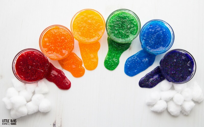 rainbow slime in clear glass bowls on white background with cotton ball shaped clouds 