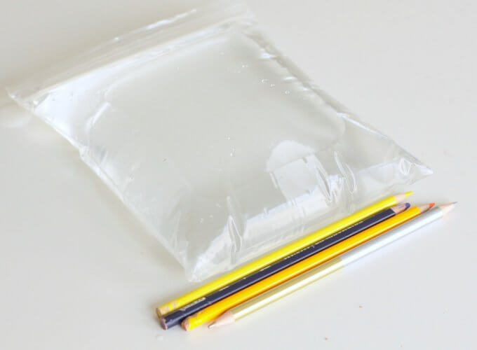 sharpened pencils and bag filled with water on table